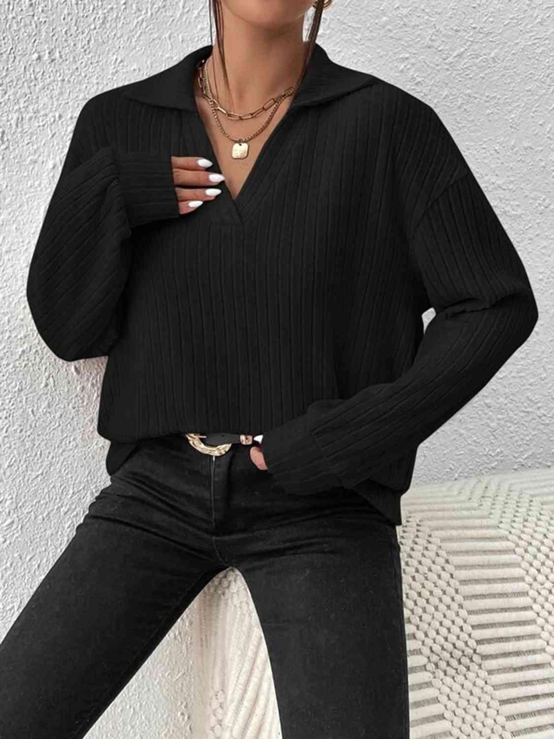 a woman wearing a black sweater and jeans