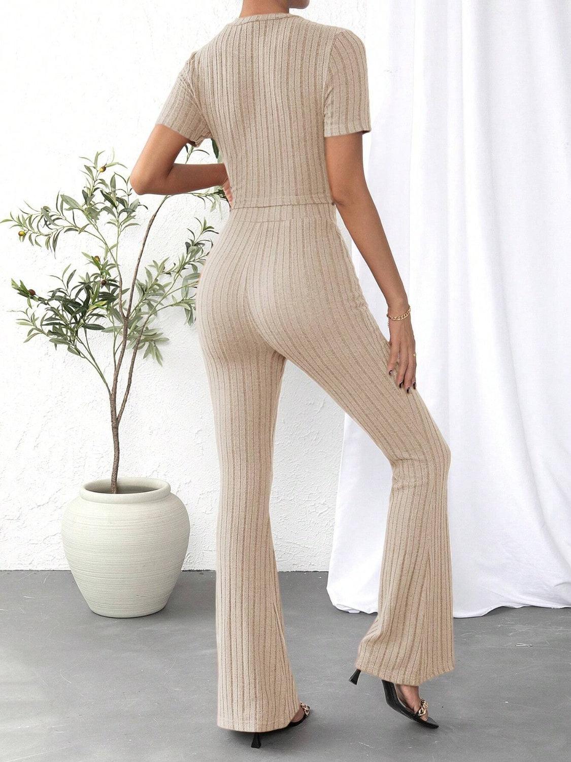 a woman wearing a beige jumpsuit and heels