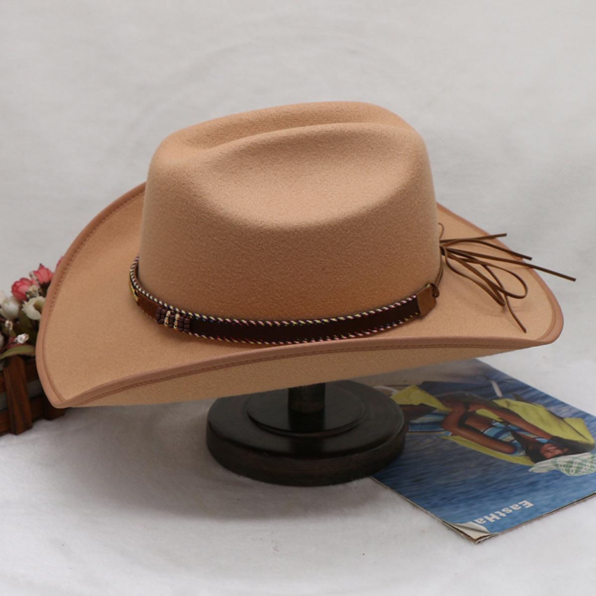 a brown hat sitting on top of a wooden stand