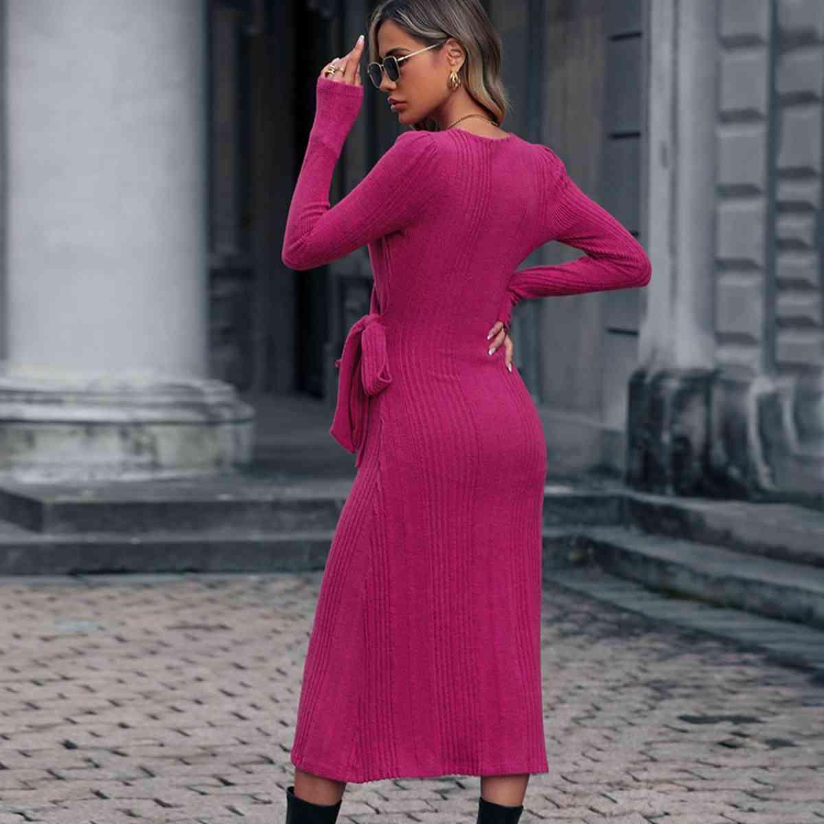 a woman in a pink dress and black boots