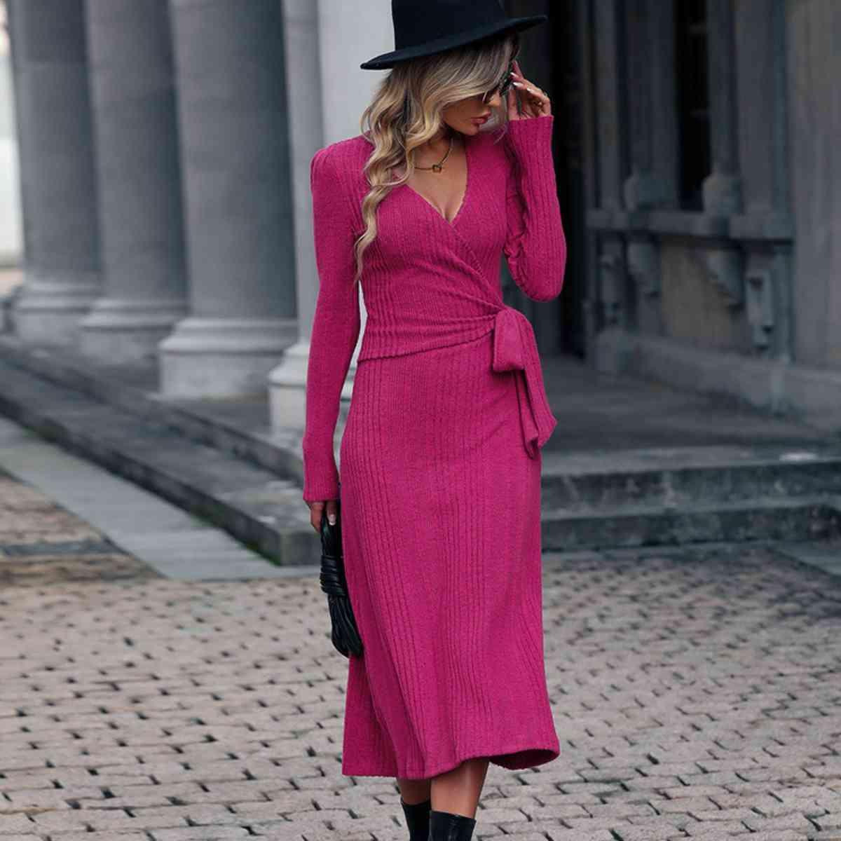 a woman in a pink dress and black hat