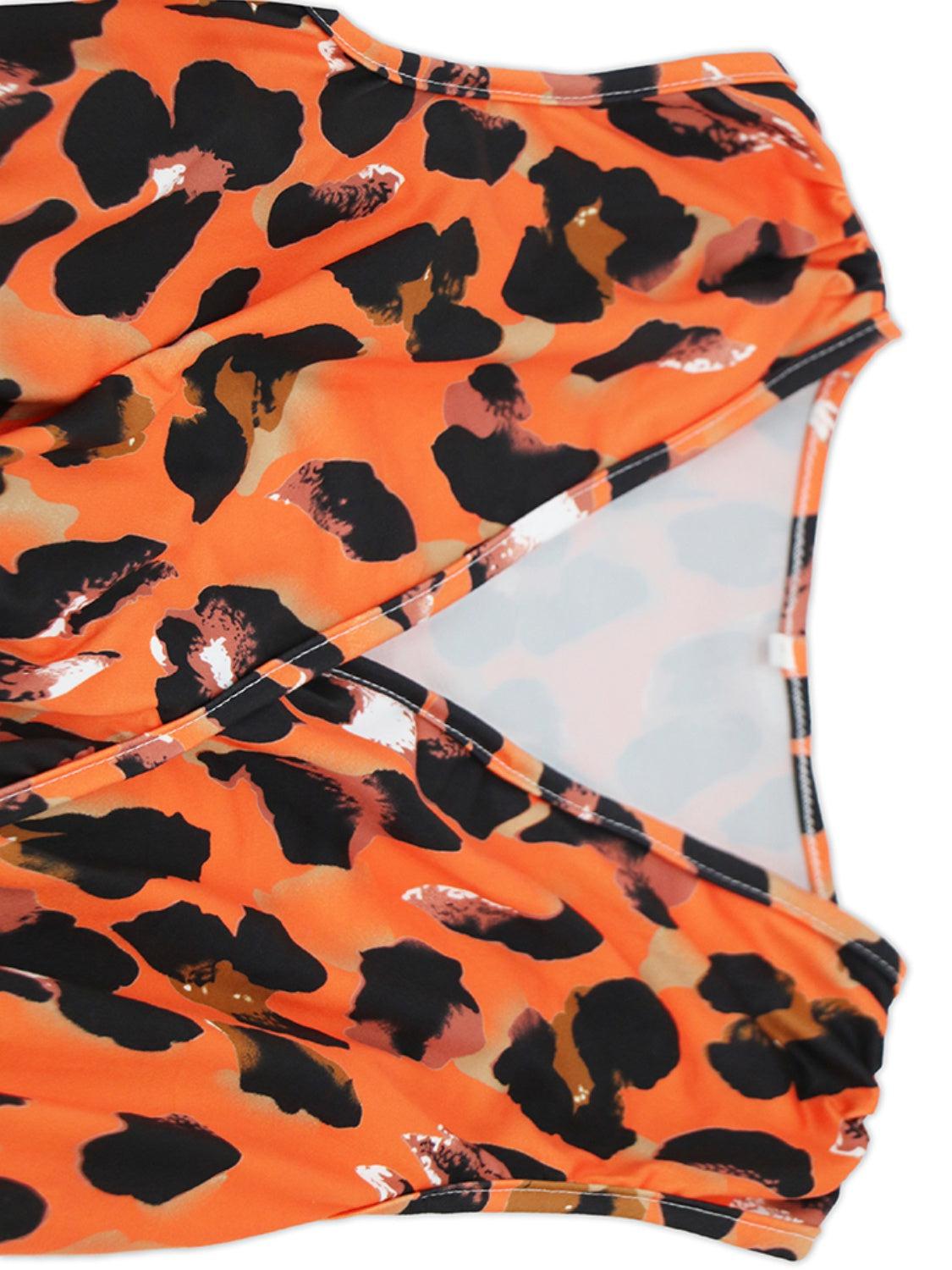 an orange and black top with a leopard print