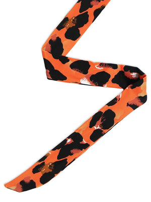 an orange and black animal print tie on a white background