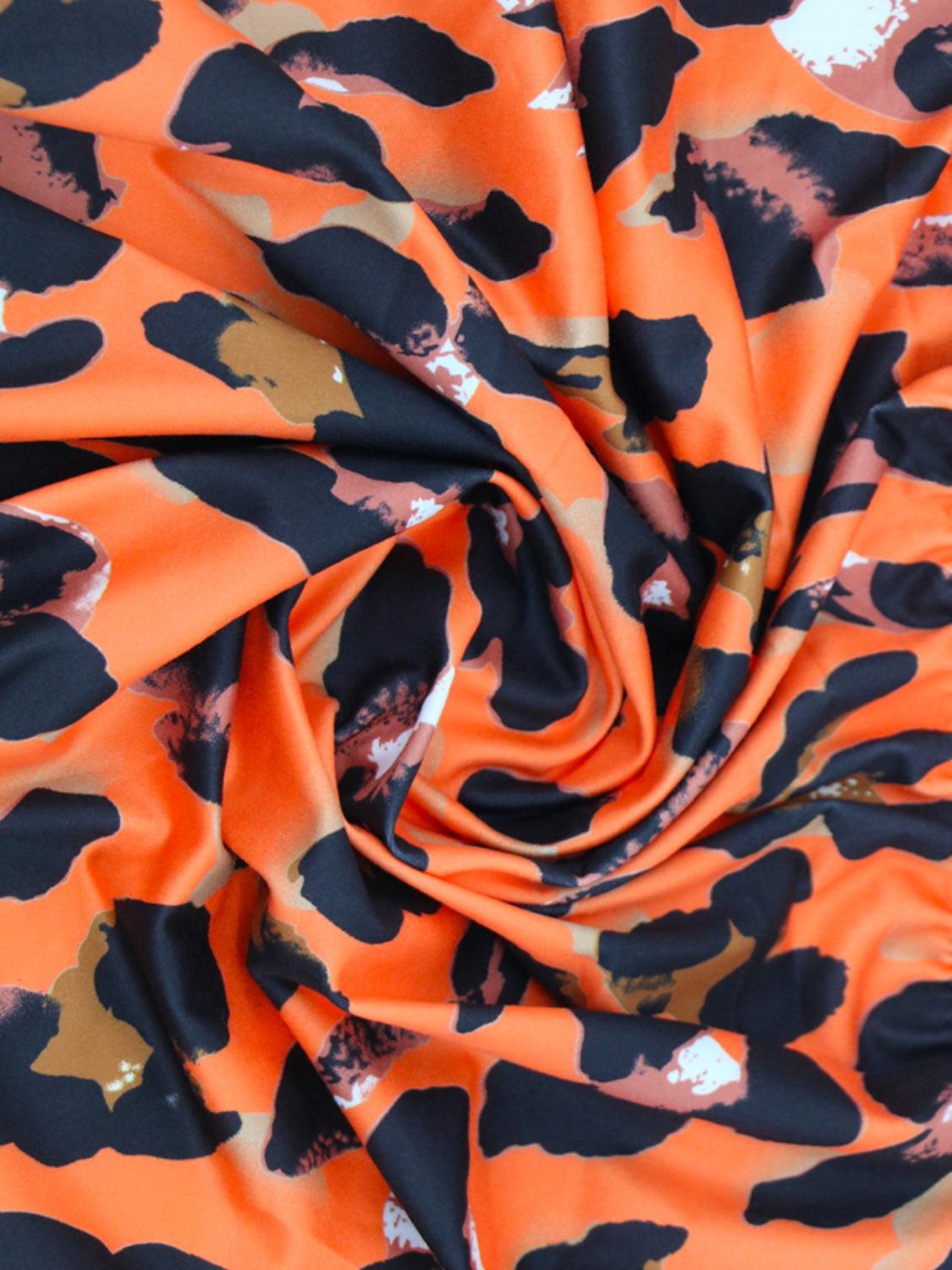 an orange and black camouflage print fabric