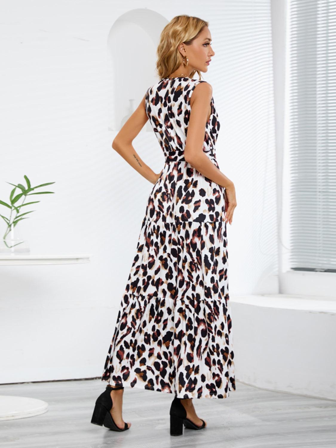 a woman standing in a room wearing a leopard print dress