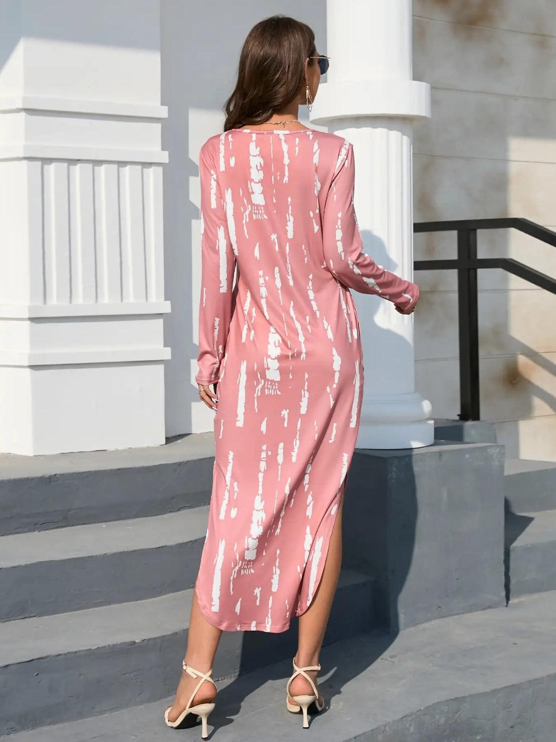 a woman in a pink dress standing on steps