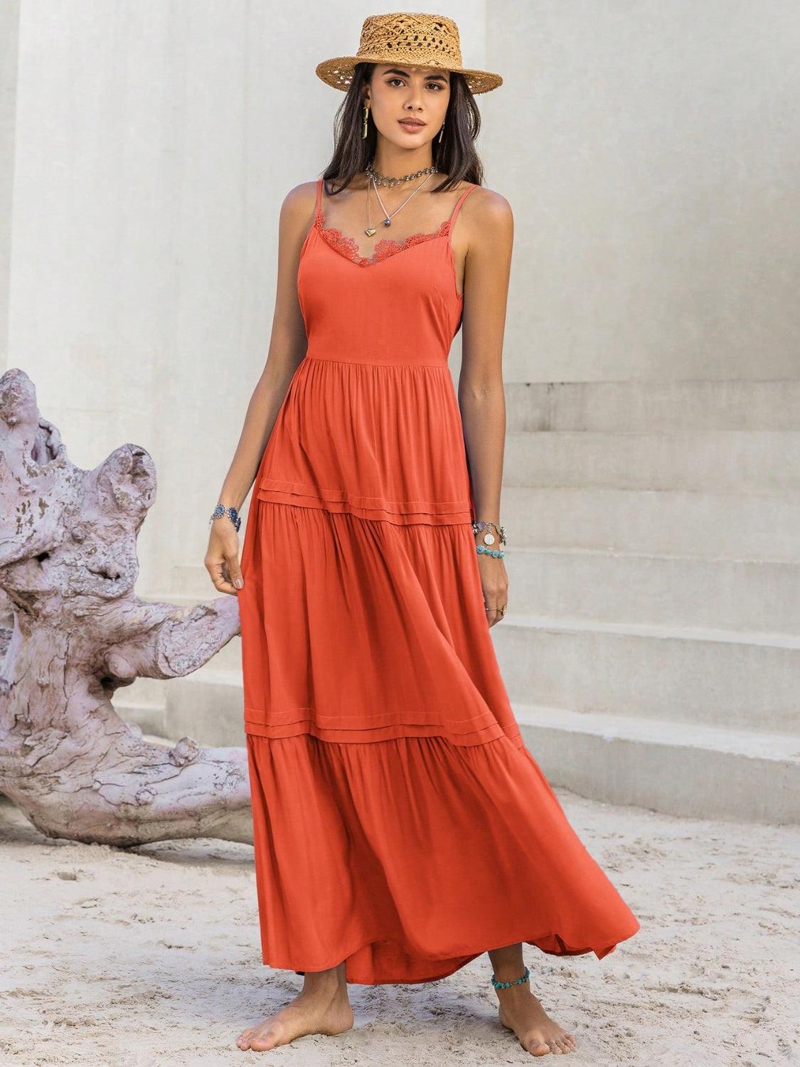 a woman in an orange dress and straw hat