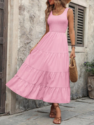 a woman wearing a pink dress and straw hat