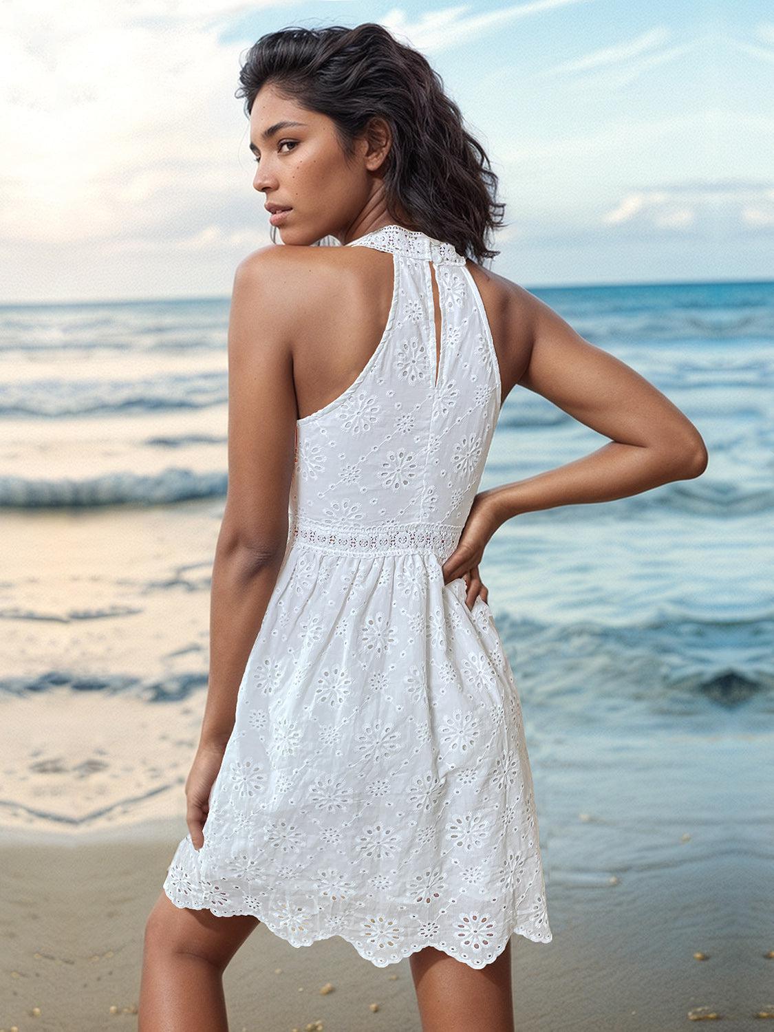 a woman in a white dress standing on a beach