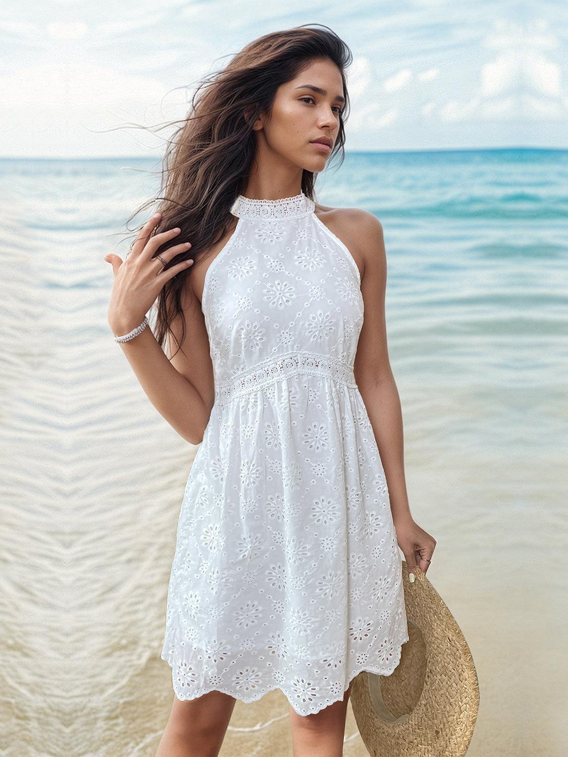 a woman in a white dress on the beach