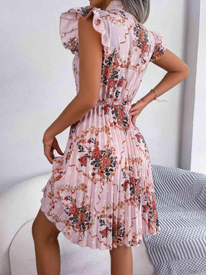 a woman wearing a pink floral print dress