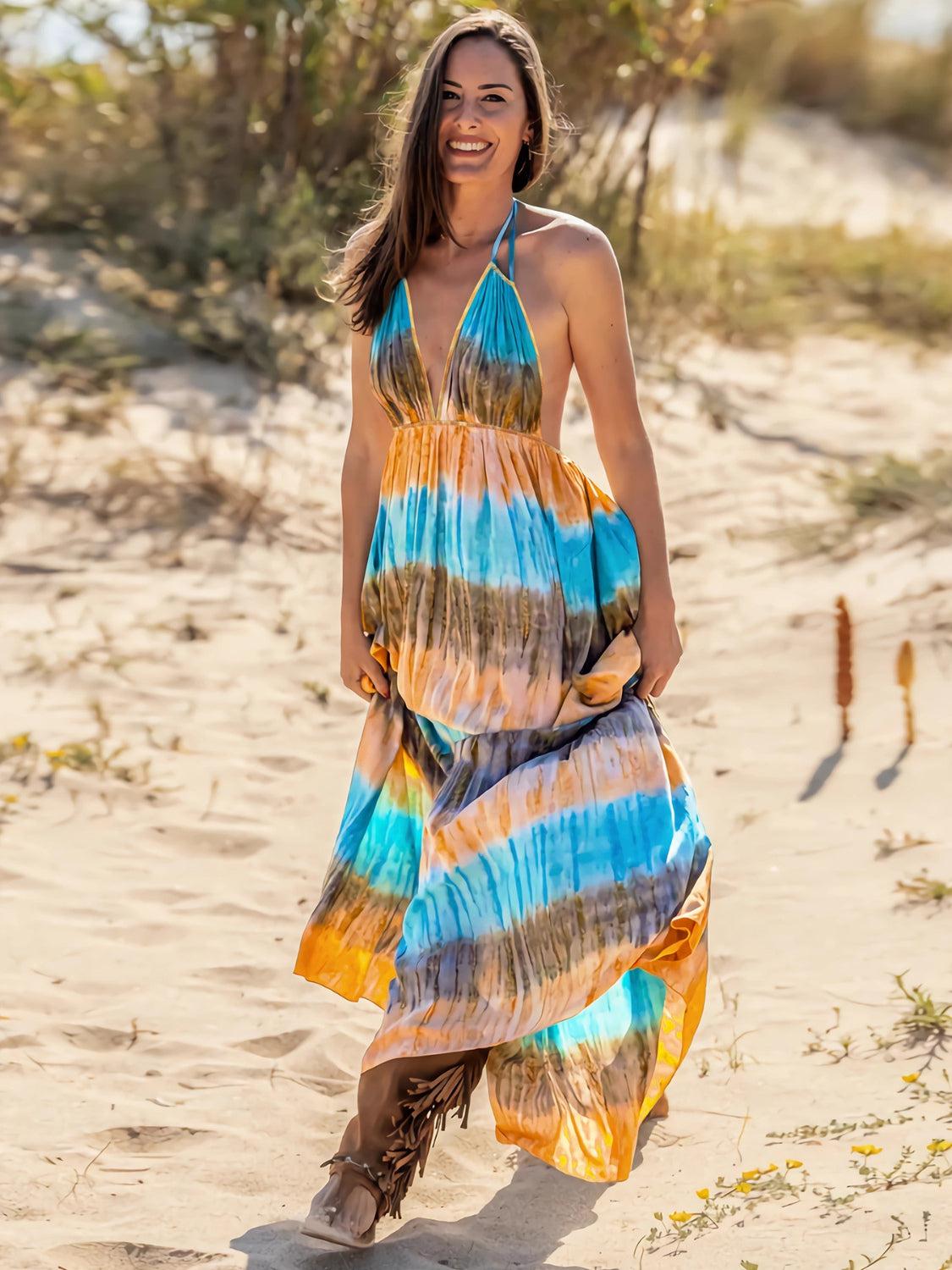 a woman in a colorful dress walking on a beach