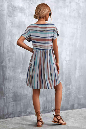 a woman wearing a striped dress and sandals