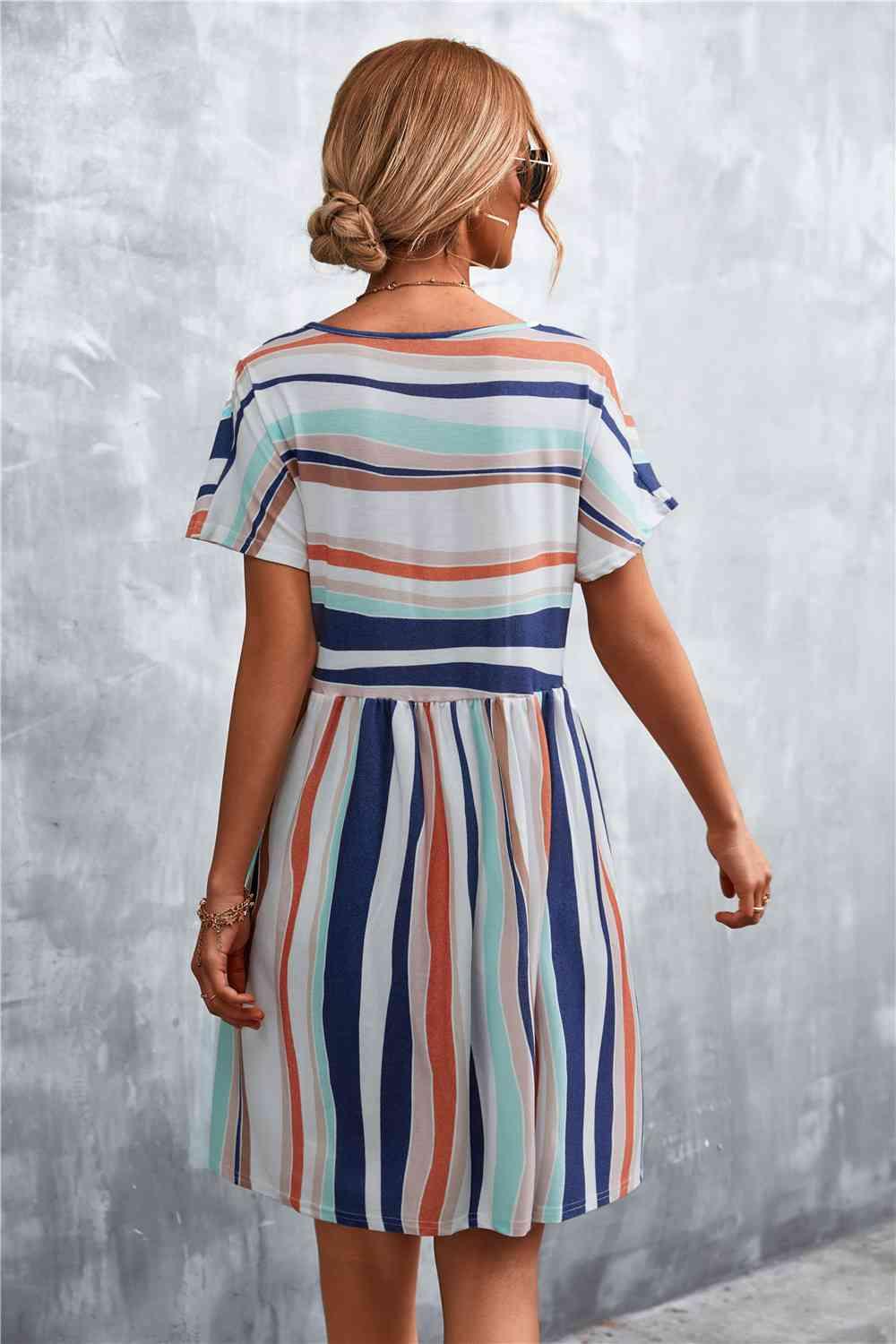 a woman wearing a striped dress