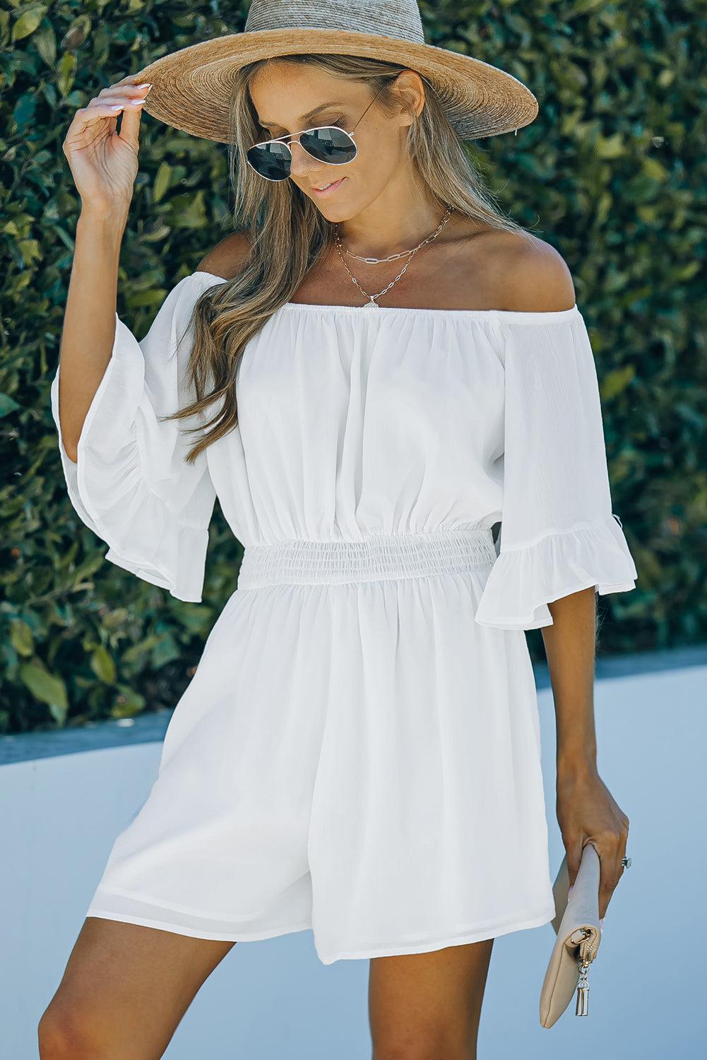 a woman wearing a white dress and hat