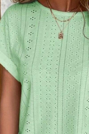 a close up of a person wearing a green shirt