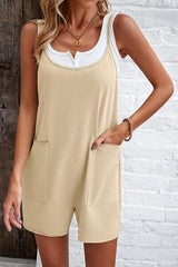 a woman wearing a tan and white romper