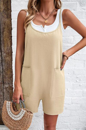 a woman wearing a tan and white romper with a straw bag