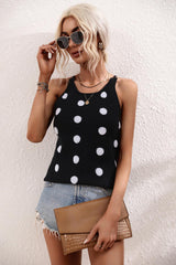 a woman wearing a black and white polka dot top