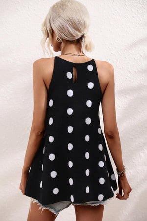 a woman wearing a black and white polka dot top