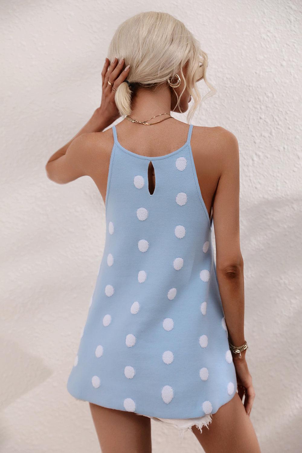 a woman wearing a blue and white polka dot dress