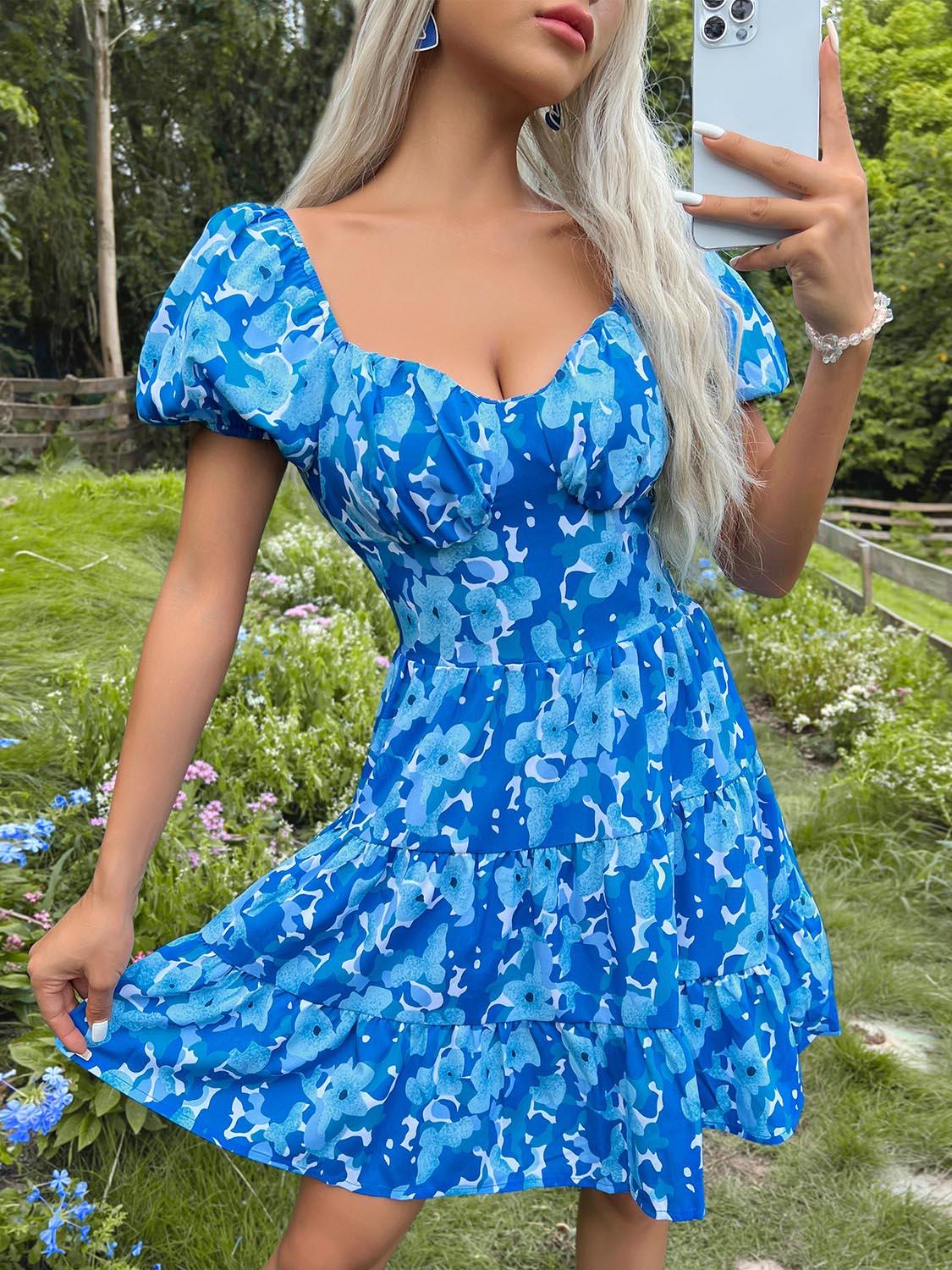 a woman in a blue dress taking a selfie