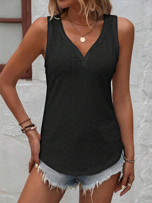 a woman wearing a black top and shorts