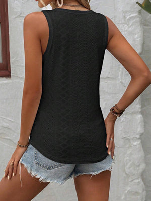 a woman wearing a black top and denim shorts