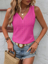 a woman wearing a pink top and denim shorts