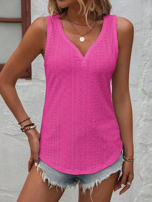 a woman wearing a pink top and denim shorts