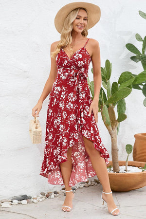 a woman wearing a red floral dress and hat