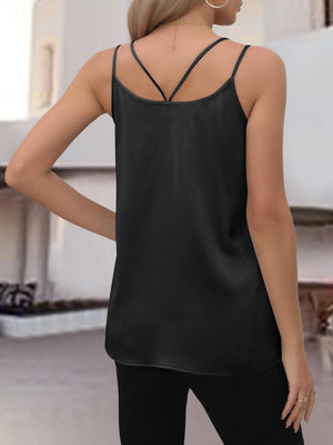 a woman wearing a black top with a cross back