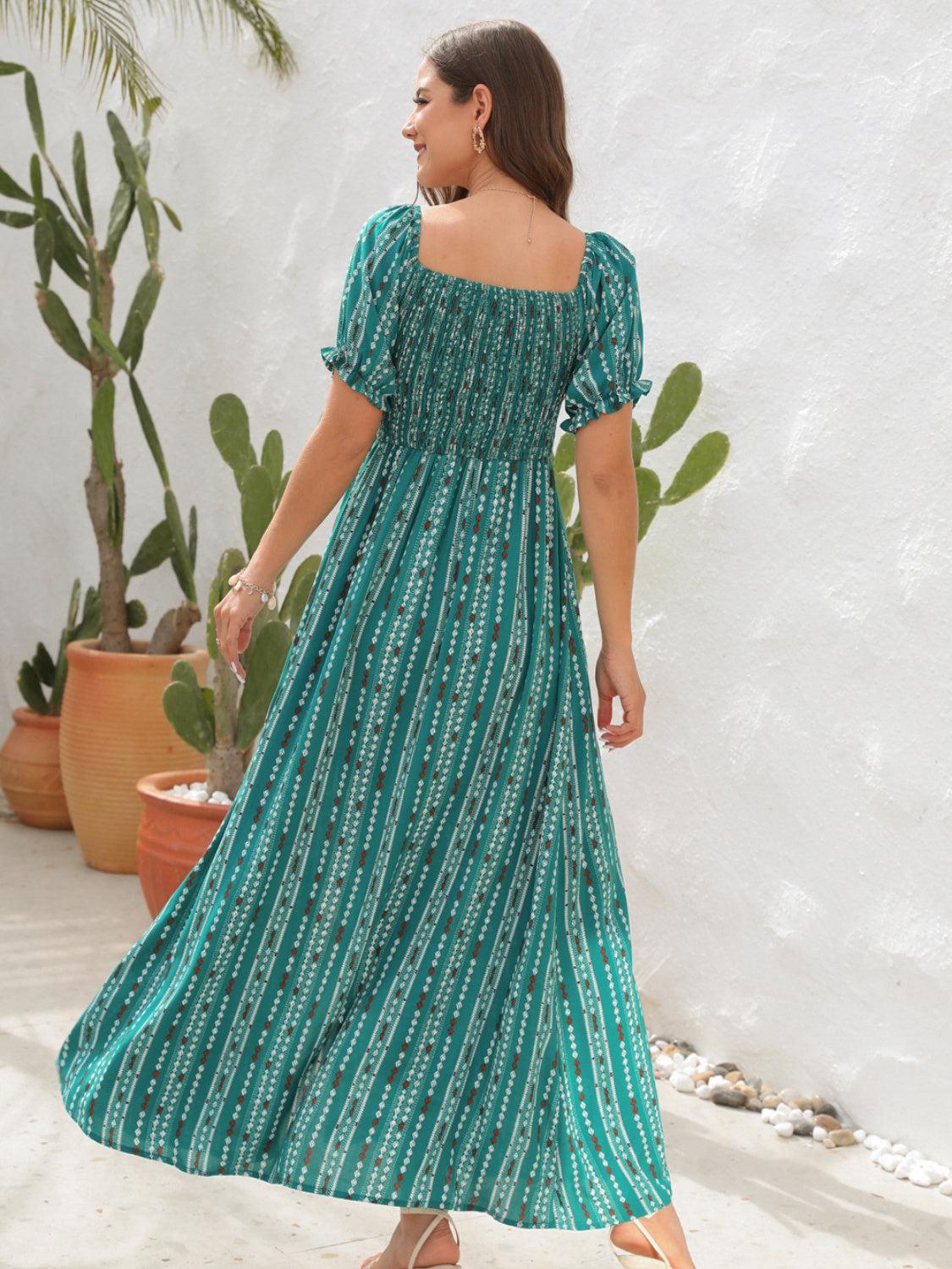 a woman in a green dress standing in front of a cactus