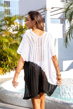 a woman walking down a street wearing a white top