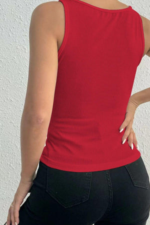 a woman wearing a red top and black pants