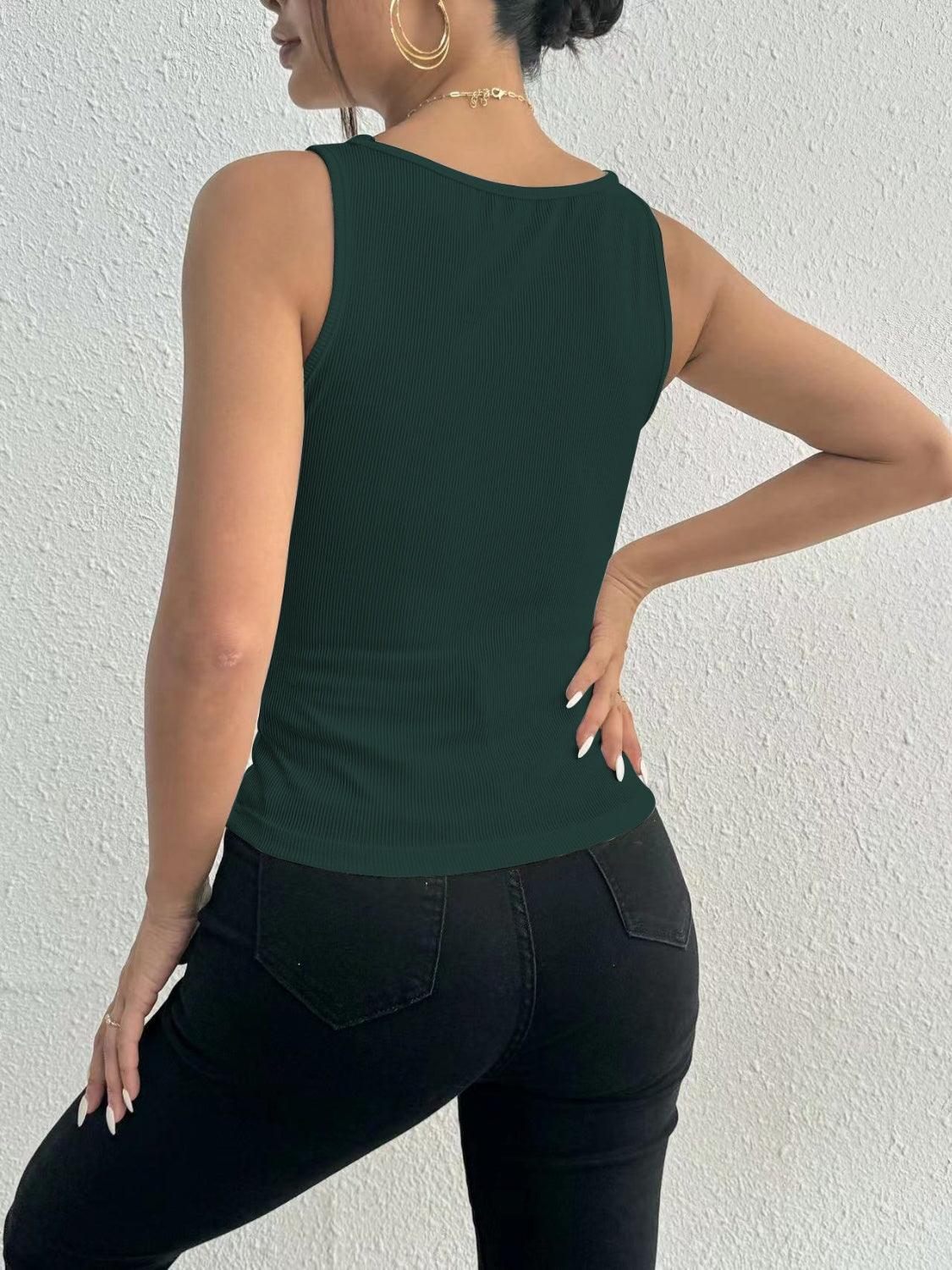 a woman wearing a green top and black pants