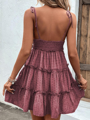 the back of a woman wearing a purple dress