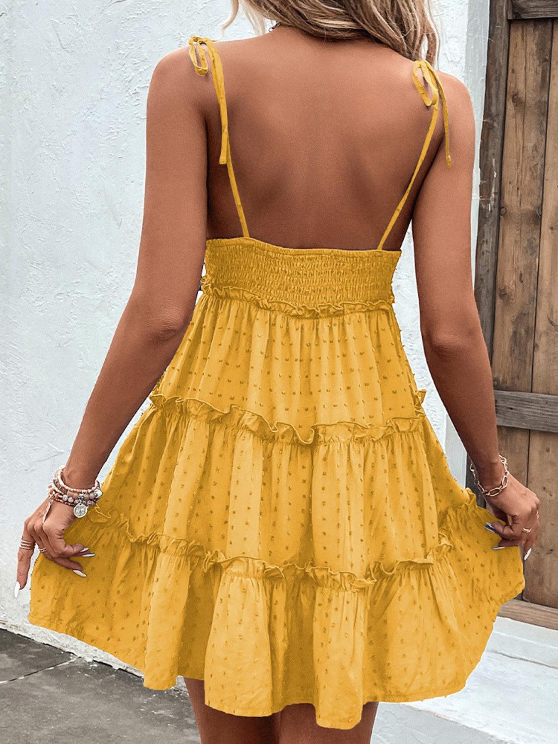 the back of a woman's yellow dress