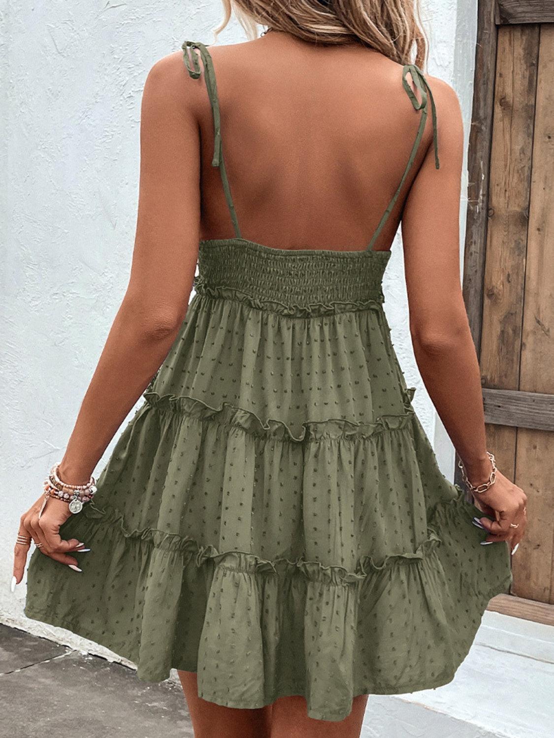 the back of a woman wearing a green dress