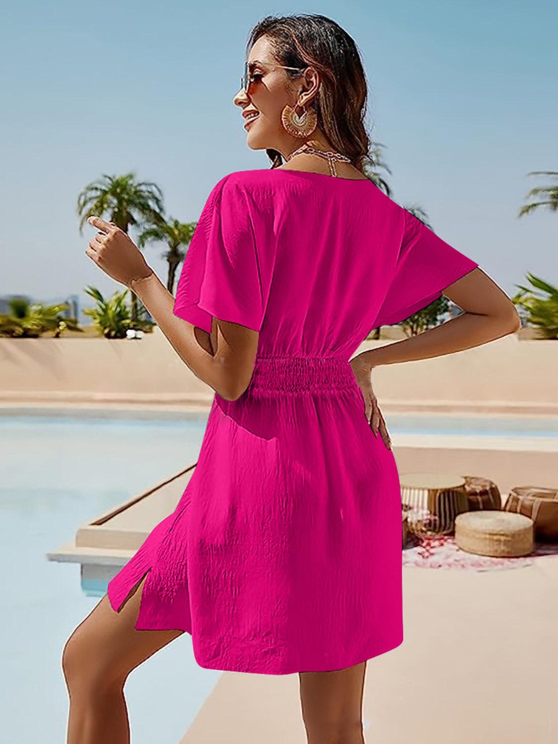 a woman in a bright pink dress standing by a pool