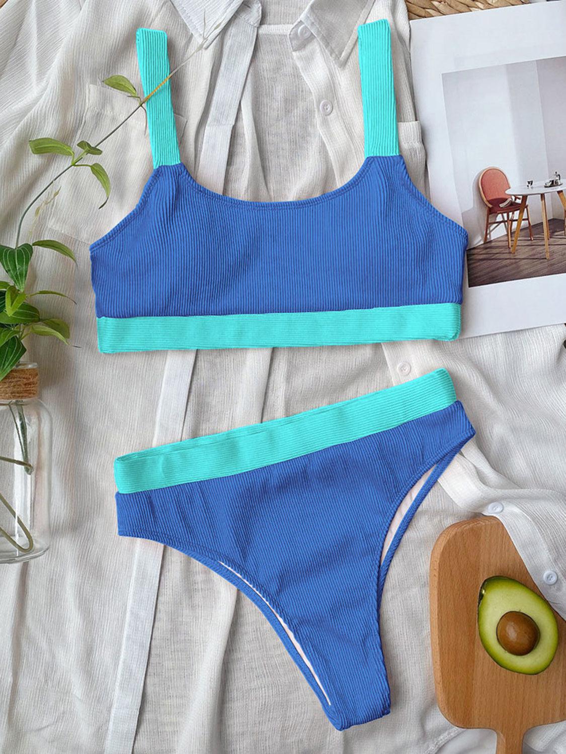 a woman's blue and green swimsuit next to an avocado