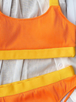 a woman's orange and white top with yellow straps