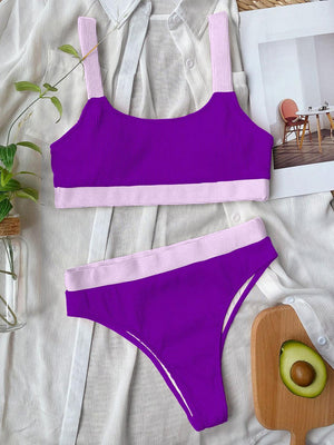 a woman's purple bikinisuit and an avocado on a bed