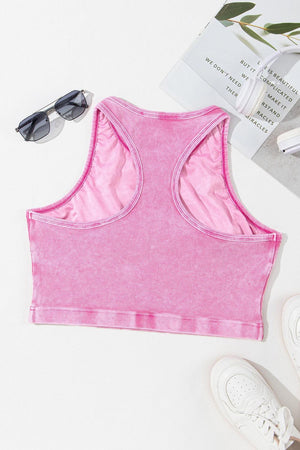 a pink sports bra top next to a pair of sunglasses