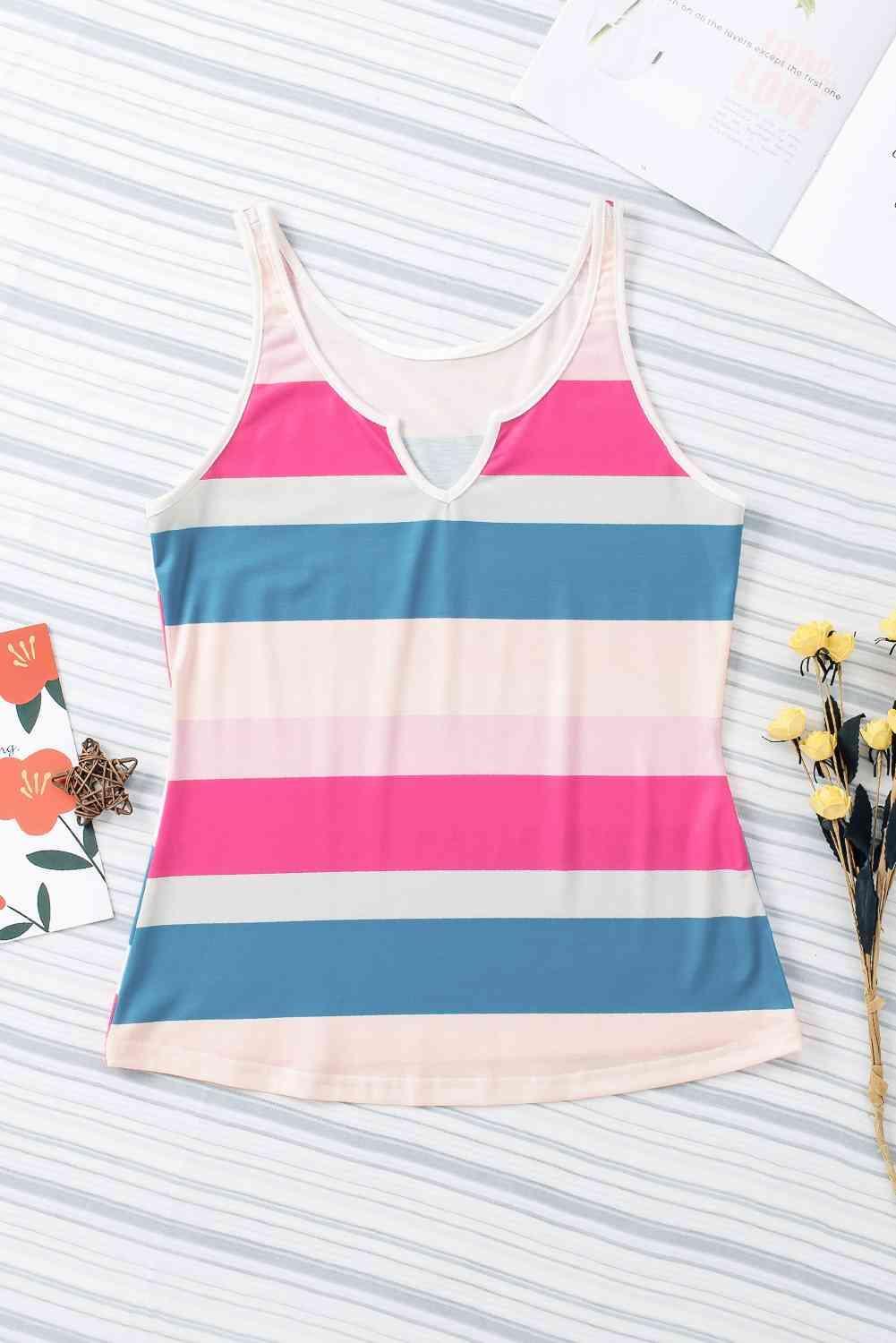 a pink and blue striped tank top next to flowers