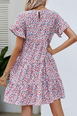 a woman wearing a red and white floral print dress