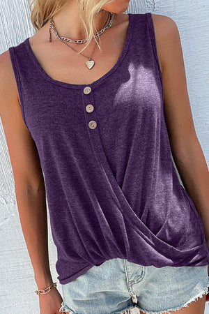 a woman wearing a purple tank top and denim shorts