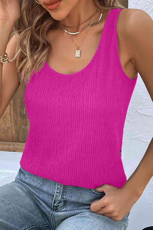 a woman wearing a pink top and jeans