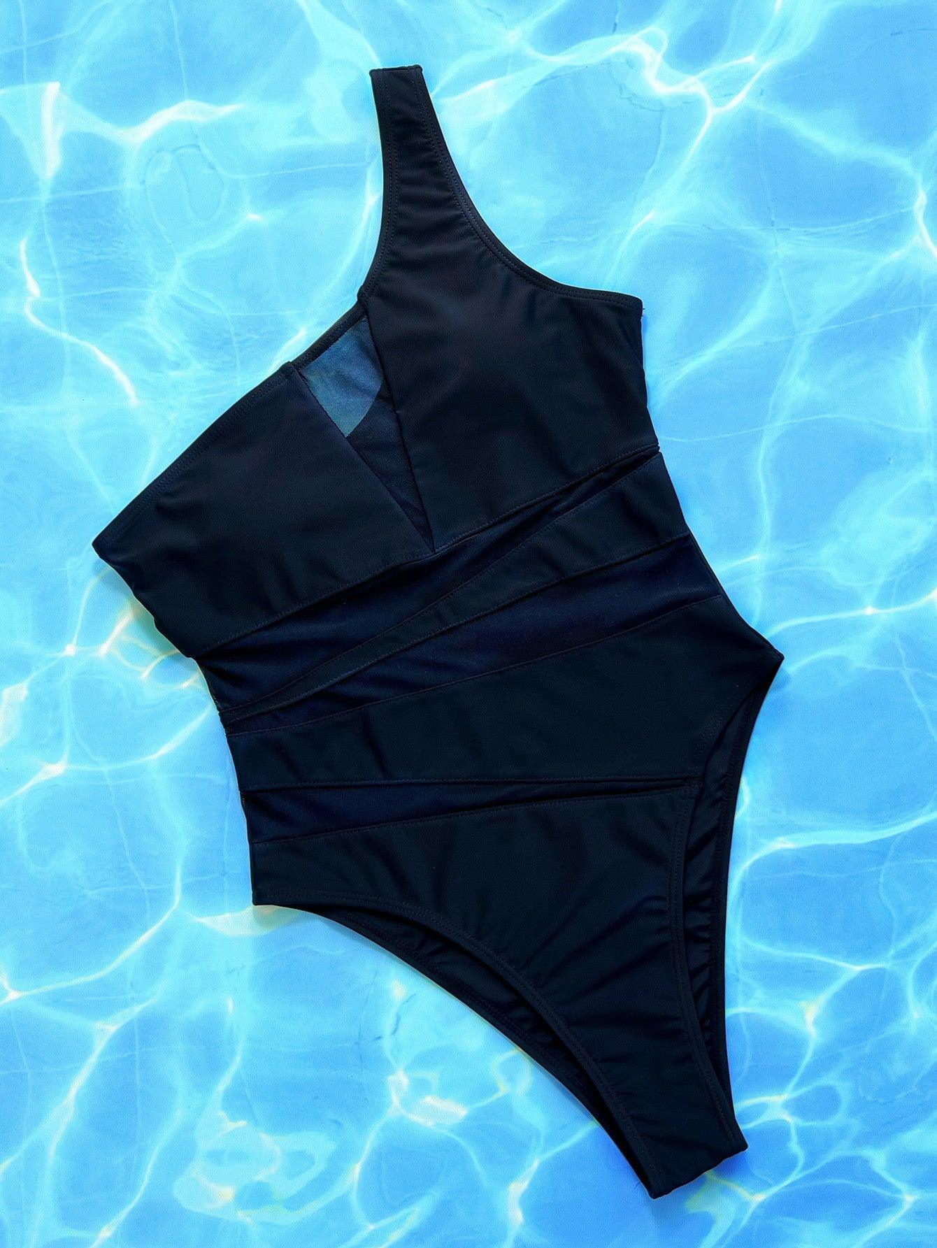 a black one piece swimsuit sitting on top of a blue pool
