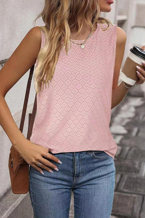 a woman in a pink top holding a cup of coffee
